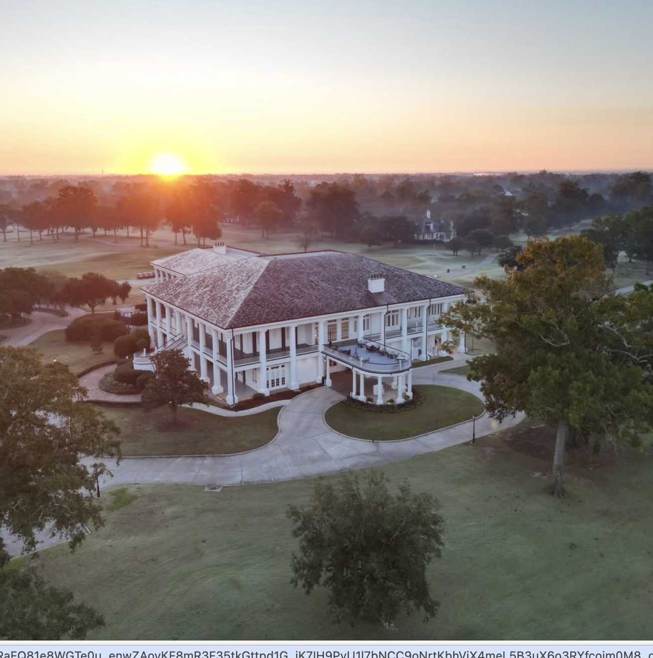 Country Club of Louisiana clubhouse at sunrise — aerial view