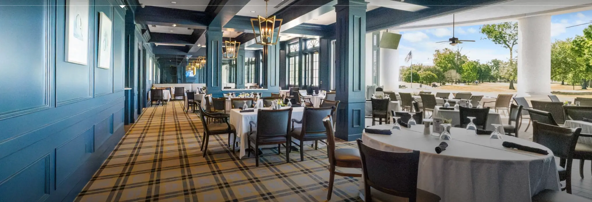 Country Club of Louisiana main dining room with plaid carpet and blue paneling