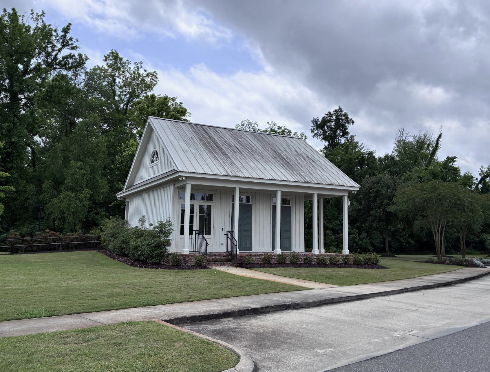 The Preserve at Harveston white farmhouse-style clubhouse with metal roof and front porch
