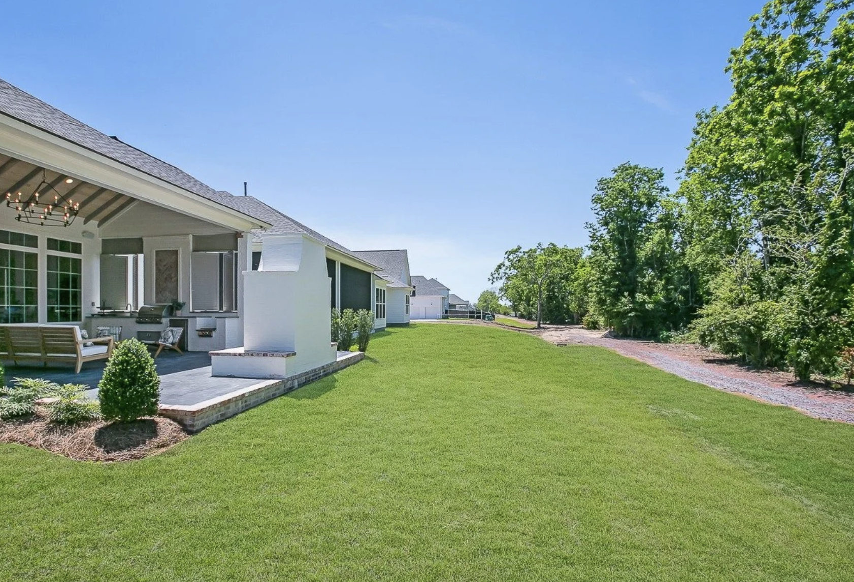 Backyard of a Preserve at Harveston home with outdoor kitchen, patio, and green space