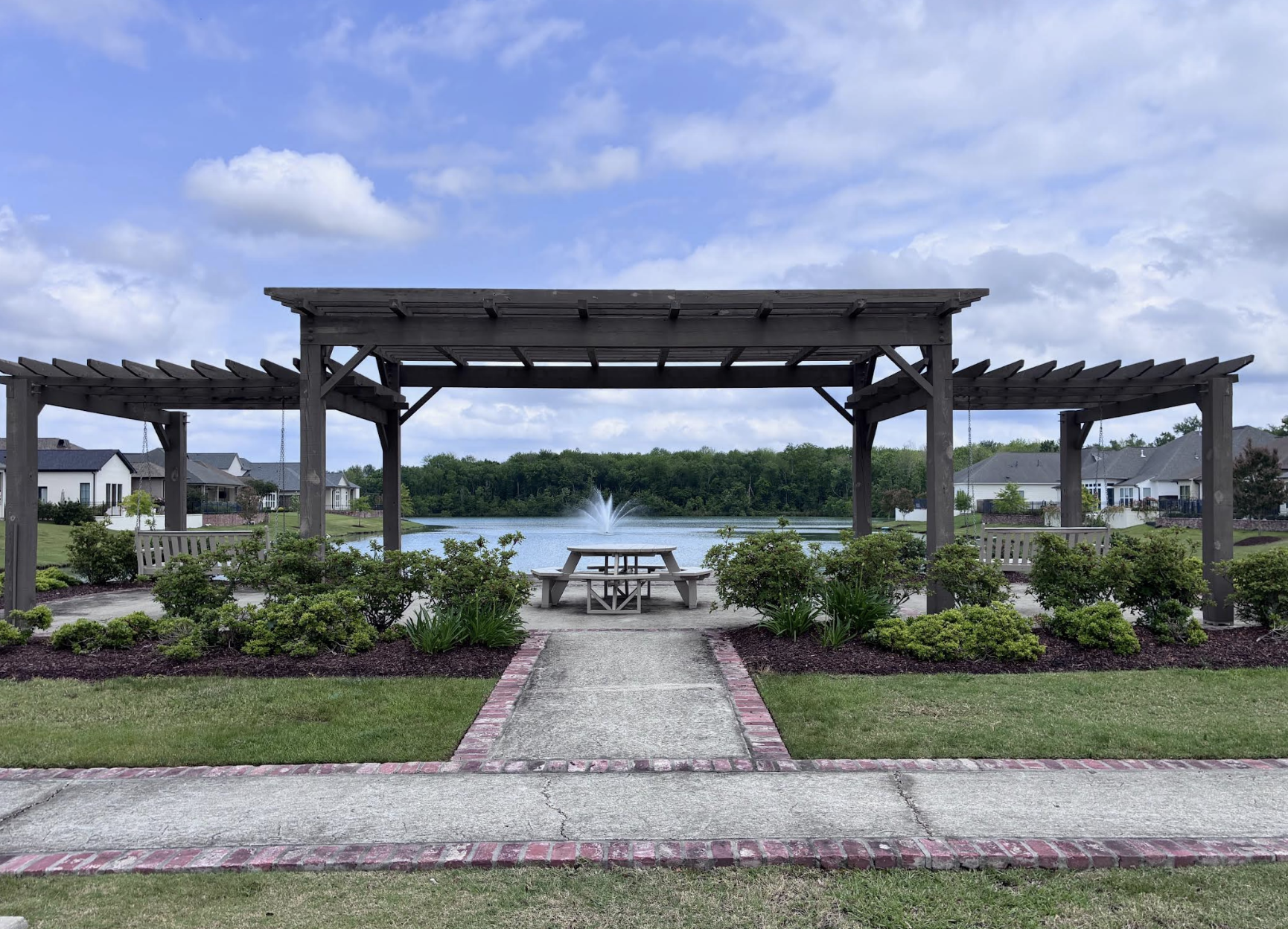 Cedar pergola overlooking the lake with fountain at The Preserve at Harveston
