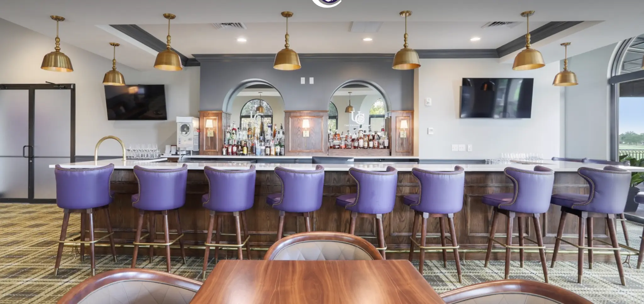 University Club bar and lounge with gold pendant lights