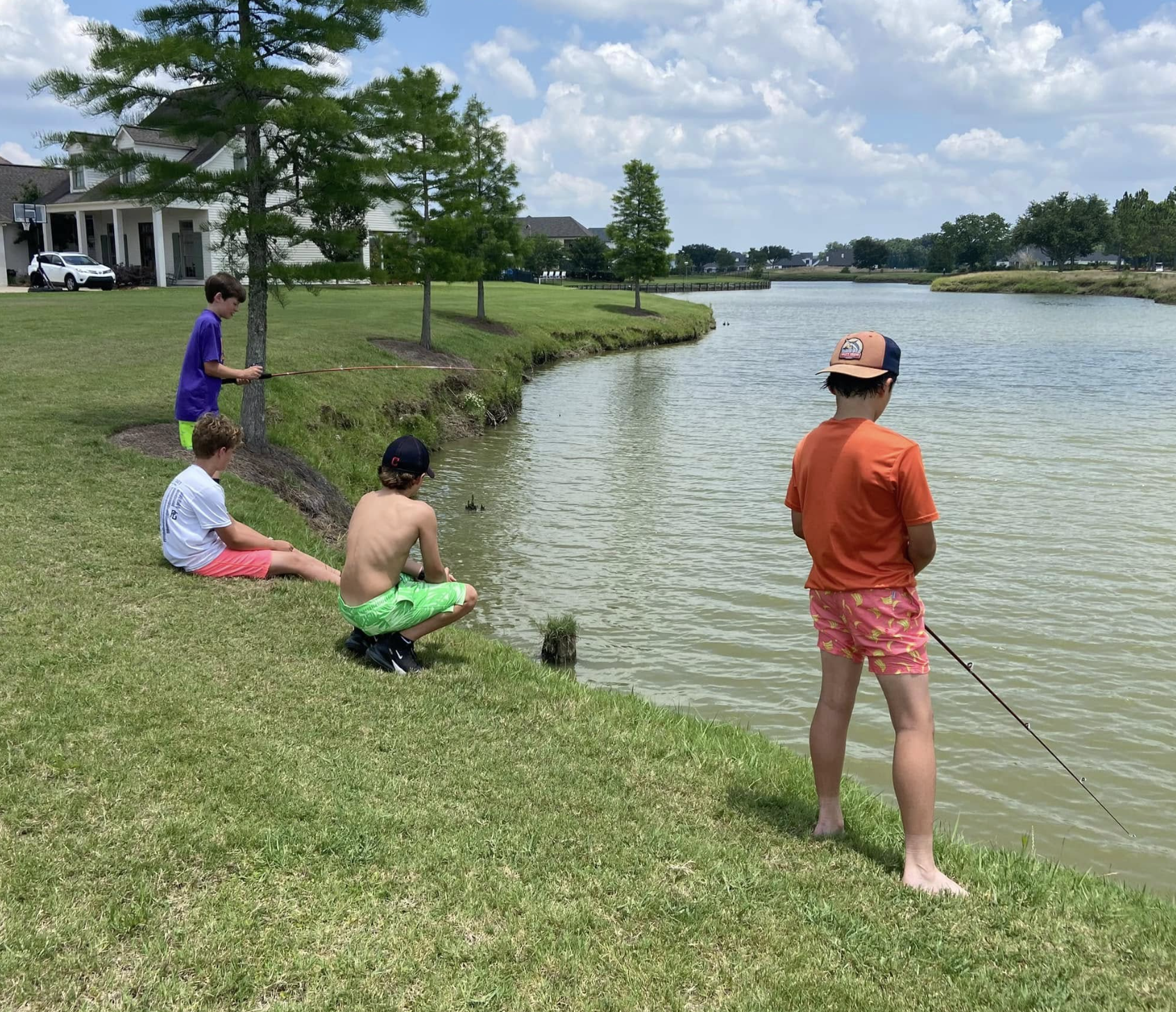 Kids fishing on the University Club lagoon