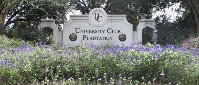 University Club Plantation entrance sign with purple flowers