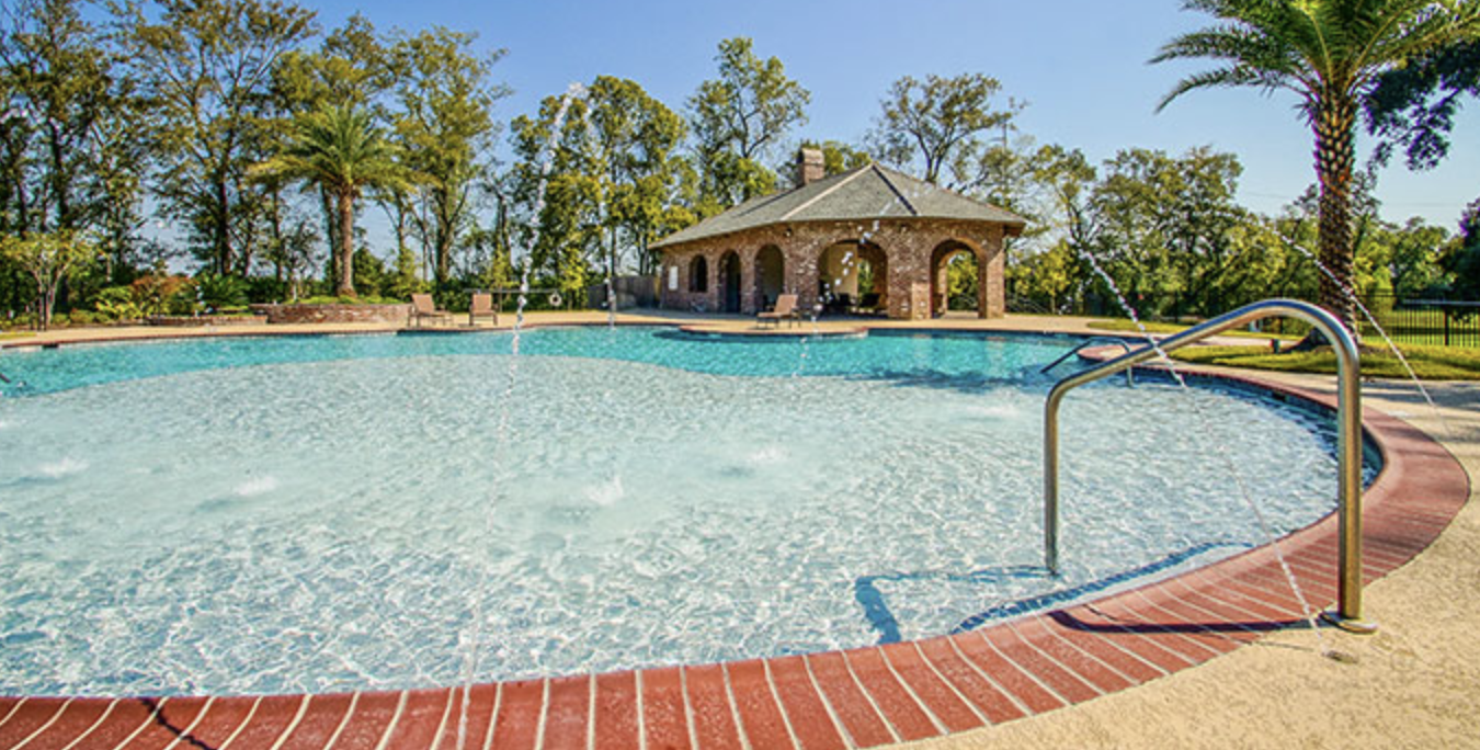 Willow Grove community pool with brick cabana and palm trees
