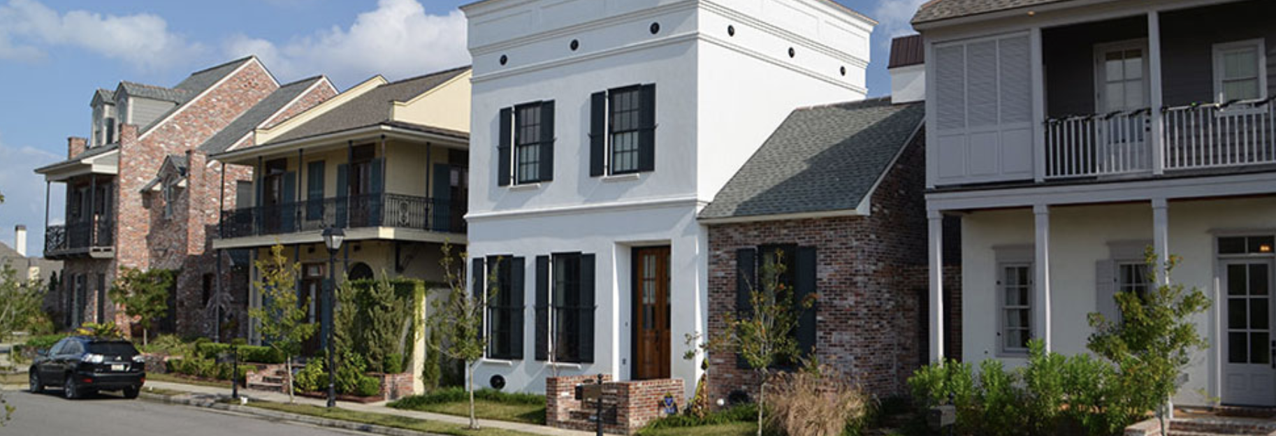 Willow Grove street scene — New Orleans-inspired townhomes with balconies